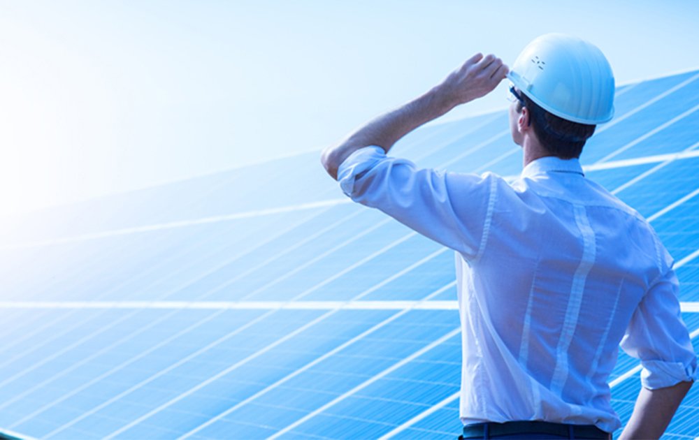 an image showing a solar panel field and a renewable energy technician - Telikoz